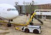 Scorching Heat Grounds Planes — Here’s Why Airplane parked at the gate with boarding bridge and ground equipment