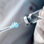 Glass In Pet Shots — Nationwide Recall A healthcare professional preparing a syringe from a vial