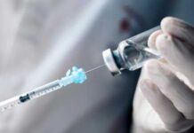 Glass In Pet Shots — Nationwide Recall A healthcare professional preparing a syringe from a vial