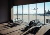 Airport Faith Fight Ignites View of an airport waiting area with an airplane taking off in the background