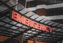 Lightning Slams Prison — 16 Rushed To Hospitals Illuminated emergency sign at a hospital entrance