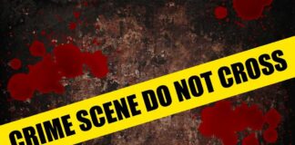 Yellow caution tape reading 'CRIME SCENE DO NOT CROSS' over a dark, blood-splattered background