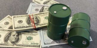 Green oil barrels on US dollar bills