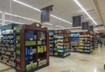 Interior view of a grocery store aisle with shelves of food and beverages