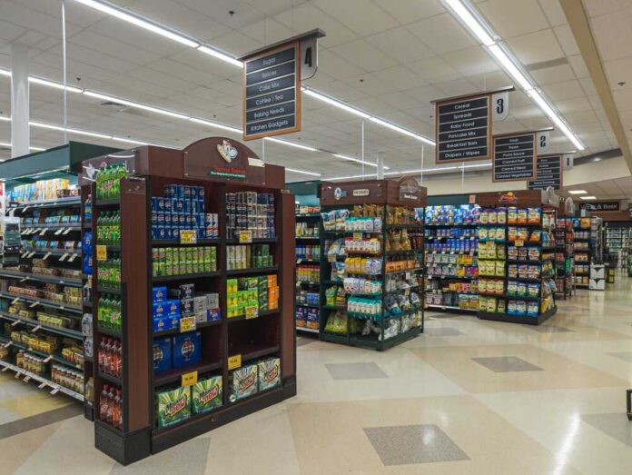 Cary,,North,Carolina,-,June,28,2025:,Shoppers,Browsing,Wide Interior view of a grocery store aisle with shelves of food and beverages