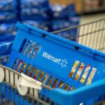 Blue shopping basket in a cart at a supermarket aisle