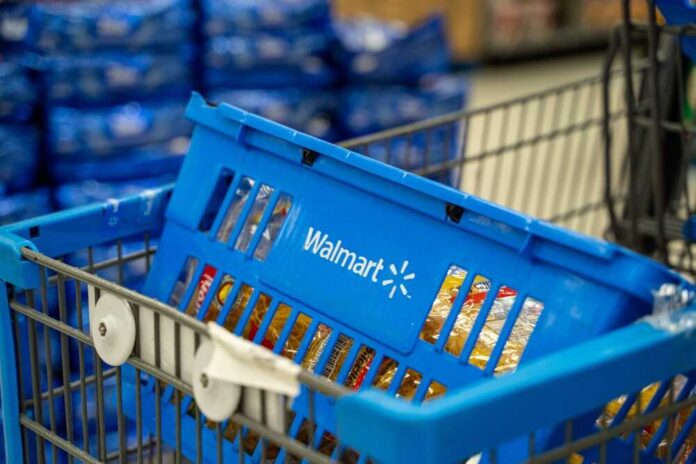 Blue shopping basket in a cart at a supermarket aisle
