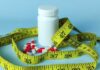 Big Pharma Blitz: Illegal Weight-Loss Crackdown A white pill bottle surrounded by red and white capsules and a yellow measuring tape