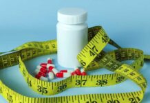 Big Pharma Blitz: Illegal Weight-Loss Crackdown A white pill bottle surrounded by red and white capsules and a yellow measuring tape