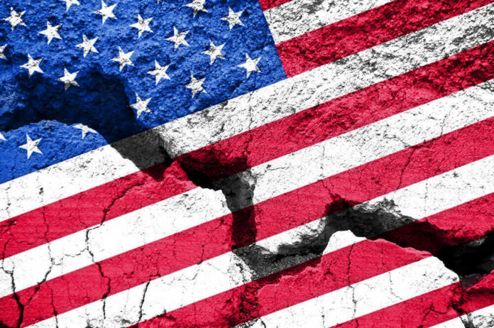 Cracked United States flag on textured surface.
