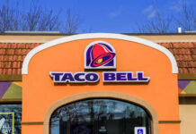 Taco Bell Lettuce Panic Explodes Exterior view of a Taco Bell restaurant with a colorful sign