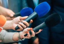 Another Body: Serial Killer Strikes Again? Reporters holding colorful microphones