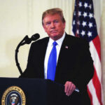 Trump’s Power Player Walks Mid-Investigation Donald Trump speaking at podium.