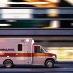 Rush-Hour Slashing Stuns Subway Platform Ambulance driving through city street at speed