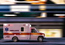 Rush-Hour Slashing Stuns Subway Platform Ambulance driving through city street at speed