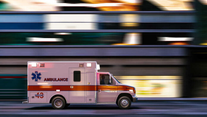 Ambulance driving through city street at speed