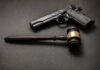 Students Ambushed – Verdict Slams Shooter Pistol and judge's gavel on dark surface