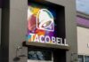 Exterior view of a Taco Bell restaurant with colorful mural