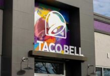 Exterior view of a Taco Bell restaurant with colorful mural