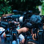 Establishment Blitz Flattens Squad Star TV news cameras crowding together at an outdoor event