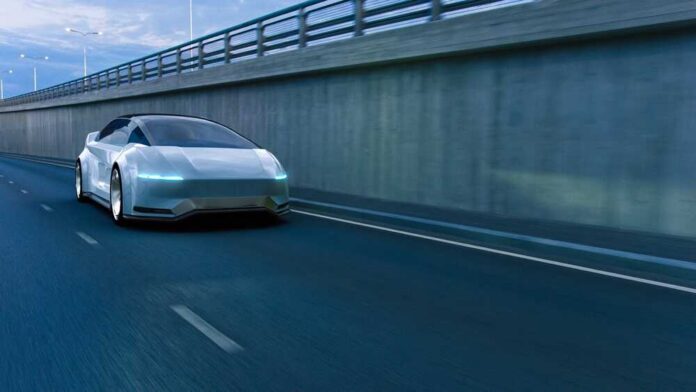 A futuristic car driving on a highway at night