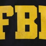 FBI Agents Exposed – Hackers Drop Chilling Proof FBI logo displayed in large yellow letters on a black background