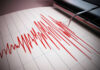 Seismograph recording earthquake activity in red.