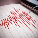 Seismograph recording earthquake activity in red.