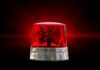Red emergency beacon light on a dark background