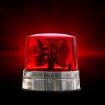 Red emergency beacon light on a dark background