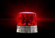 Red emergency beacon light on a dark background