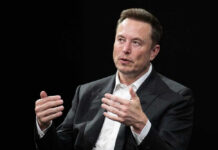 Musk’s $50K Bet Before Big Reveal Elon Musk speaking and gesturing with hands in discussion.