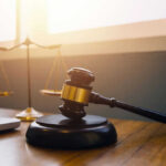 Judge Orders Forced Feeding Of THIS Prisoner Gavel and scales of justice on desk.