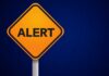 ALERT: Deadly Surge Explodes Past 6,100 Orange alert sign with the word 'ALERT' displayed prominently