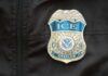 ICE Agent Arrested In Blue State – Details Here Close-up of an ICE officer badge on a black jacket