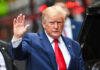 Trump’s Flag Over Neighbors Sparks Uproar Donald Trump waving.