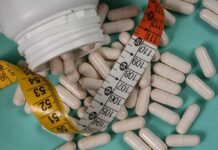 Cheap Weight Loss Shots, Filthy Risks – FDA Attacks White capsules scattered around a measuring tape and a bottle
