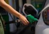 Person refueling a car at a gas station