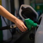 Person refueling a car at a gas station
