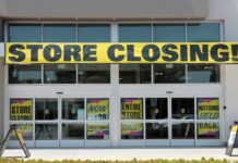 Storefront with a large 'STORE CLOSING!' banner and sale signs