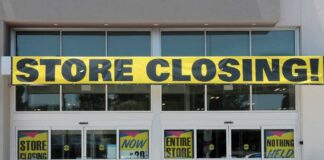 Storefront with a large 'STORE CLOSING!' banner and sale signs