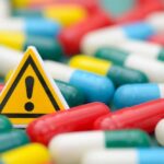 Warning sign among colorful capsules