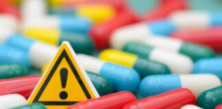 Warning sign among colorful capsules