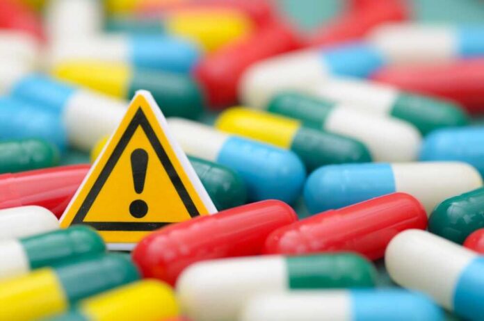 Warning sign among colorful capsules