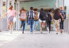 VIDEO: Miracle Bell Saves 900 Children Children running with backpacks outside a school building.