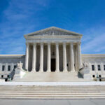 Supreme Court Gets Trump To Surrender U.S. Supreme Court building under clear blue sky.