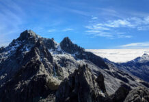Snowy mountain peaks under clear blue sky.