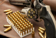 Revolver and bullets on a leather surface.