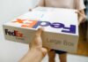 Person handing over a FedEx package to another individual