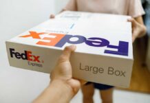 Person handing over a FedEx package to another individual